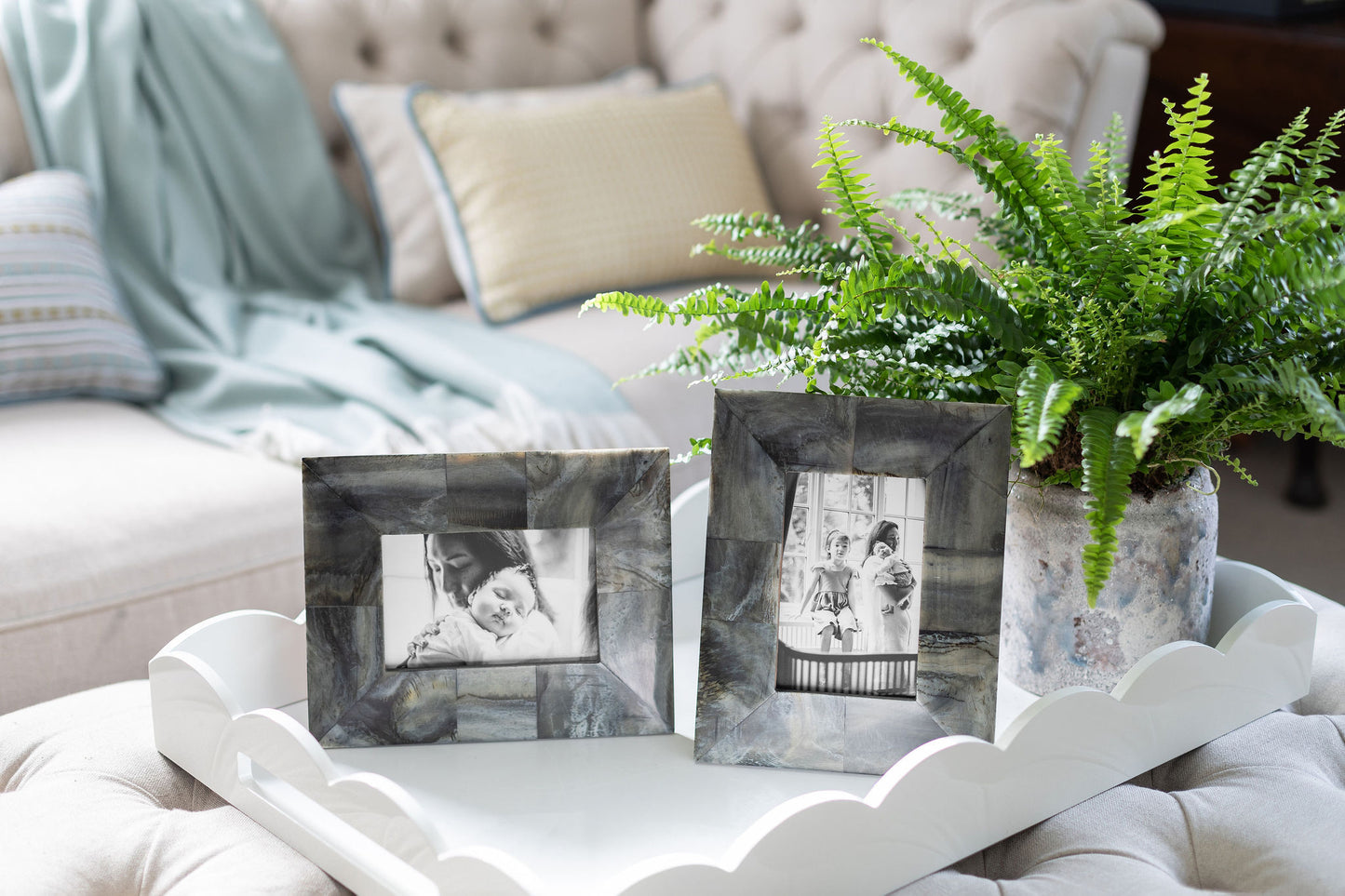 Photo frames on a large white lacquer tray