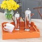 Coffee pots and cups on an orange lacquer tray with a scalloped edge