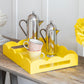 Coffee pots and cups on a yellow lacquer tray with a scalloped edge