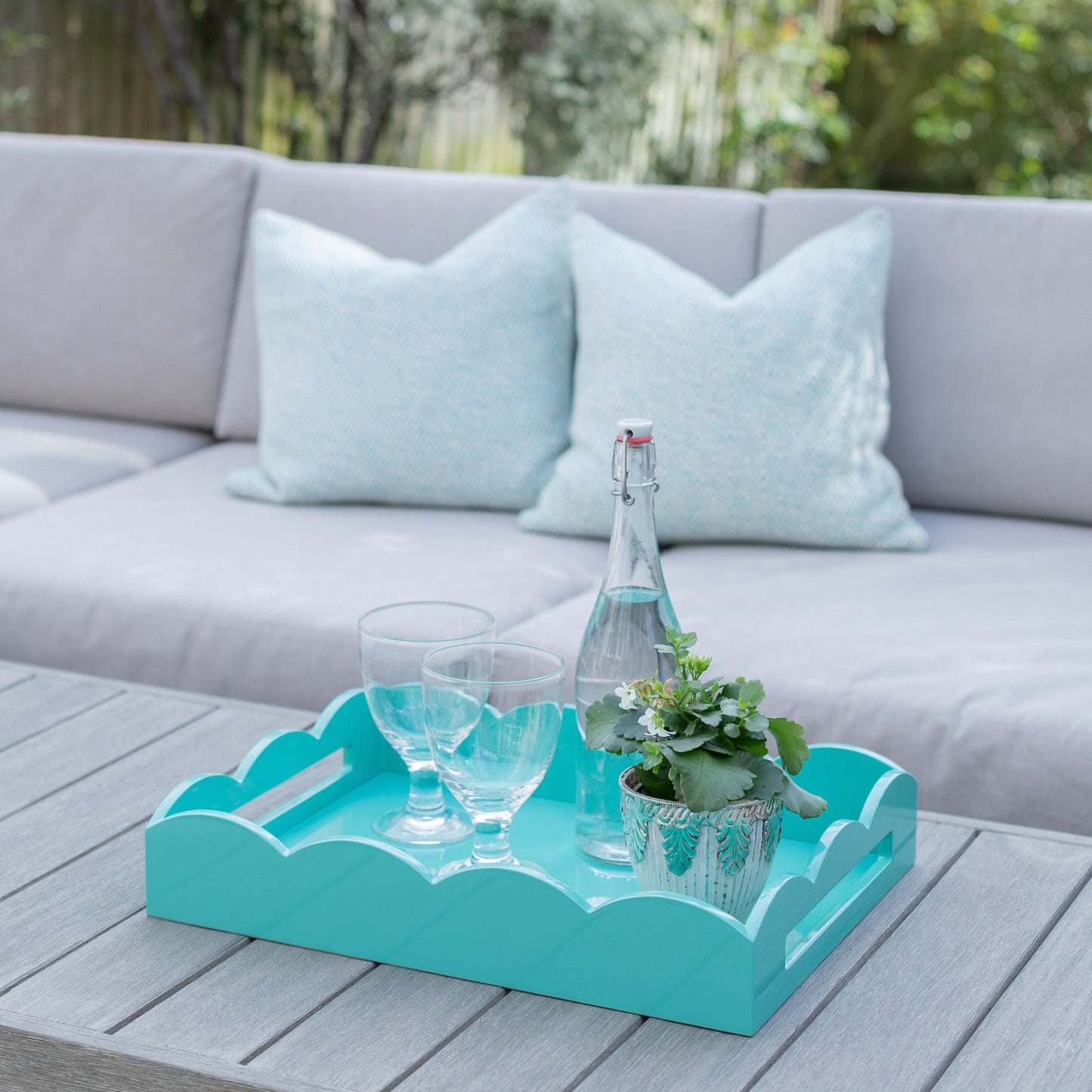 Drinks served on a turquoise blue lacquer tray with a scalloped edge
