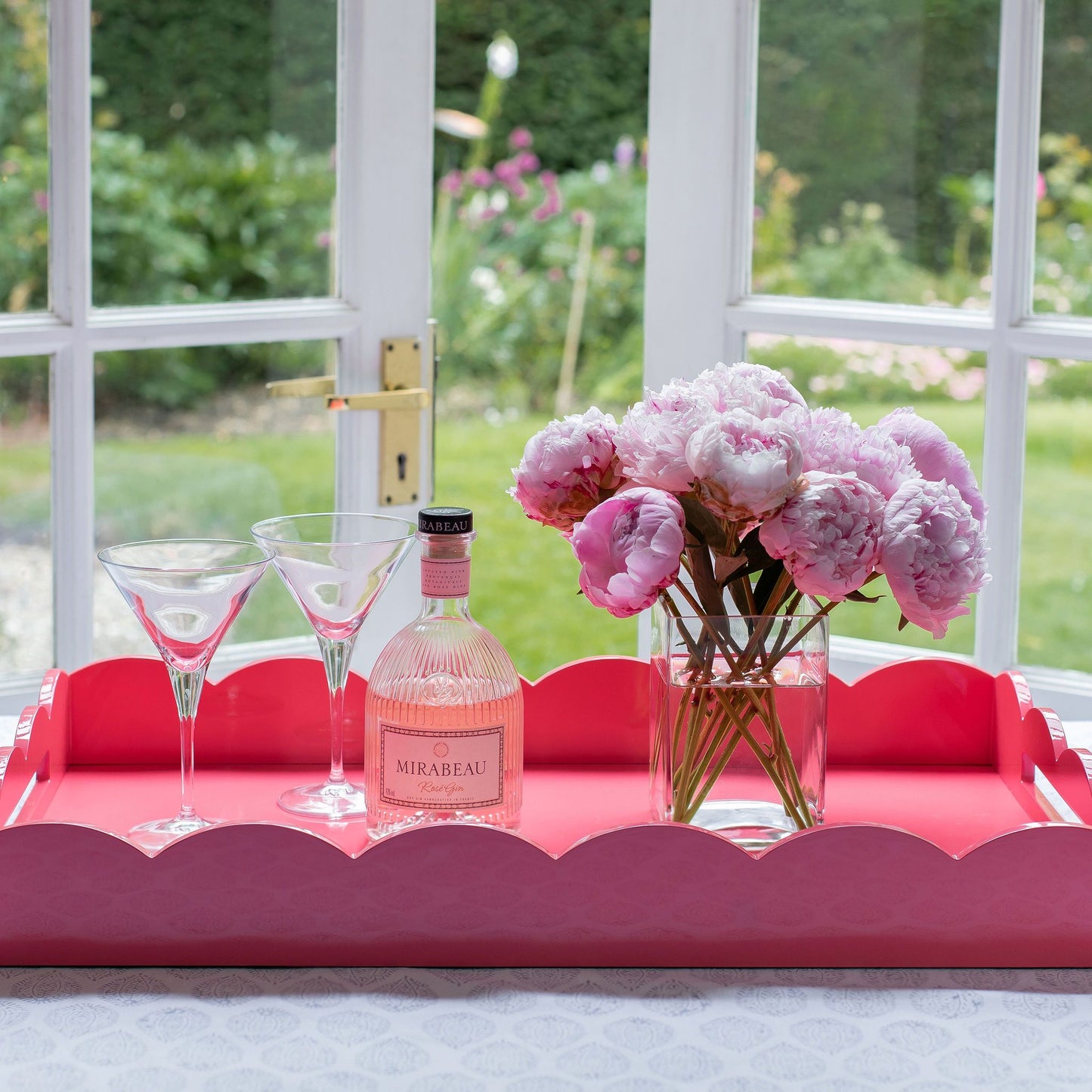 Drinks served on a large pink lacquer tray