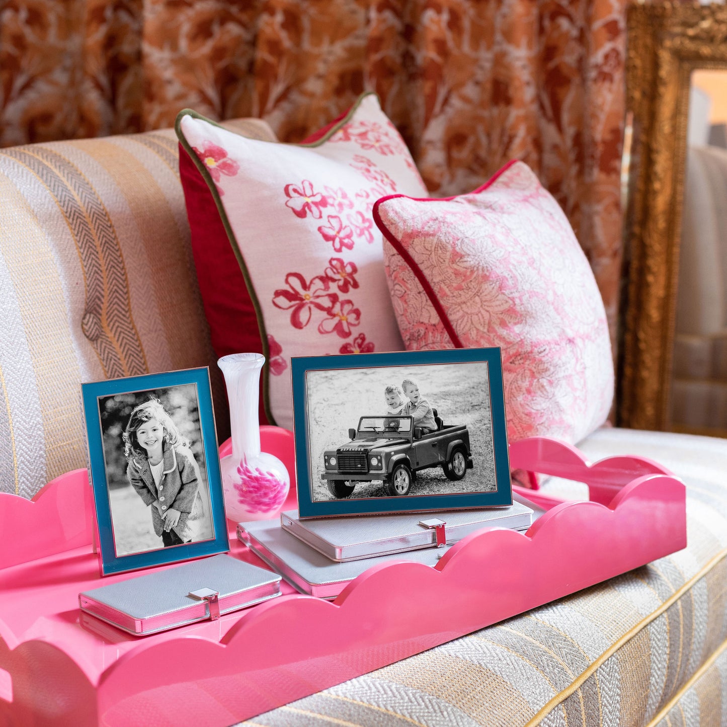 Photo frames on a large pink lacquer tray