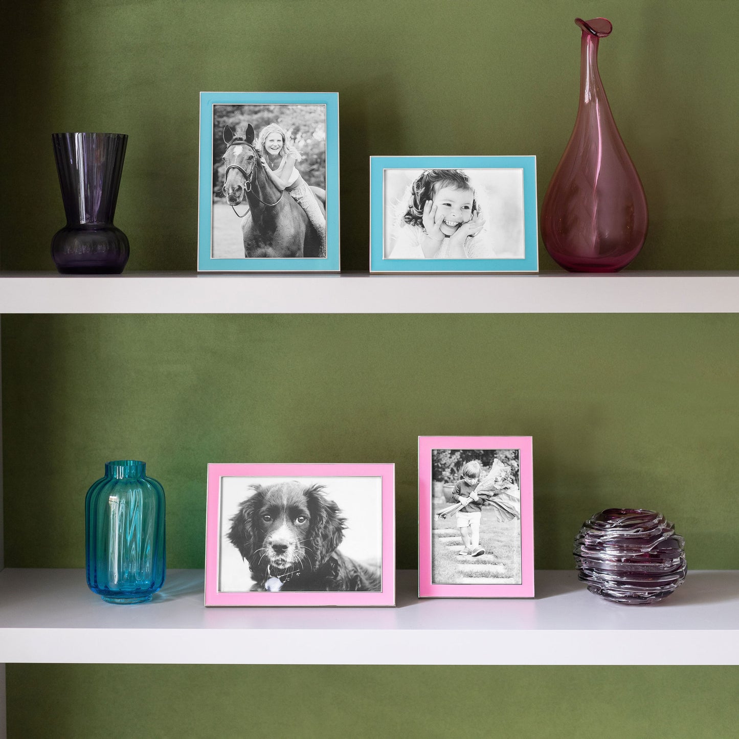 Four Silver Trim, Enamel Photo Frames on a bookshelf