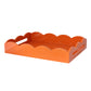 Orange lacquer serving tray with a scalloped edge